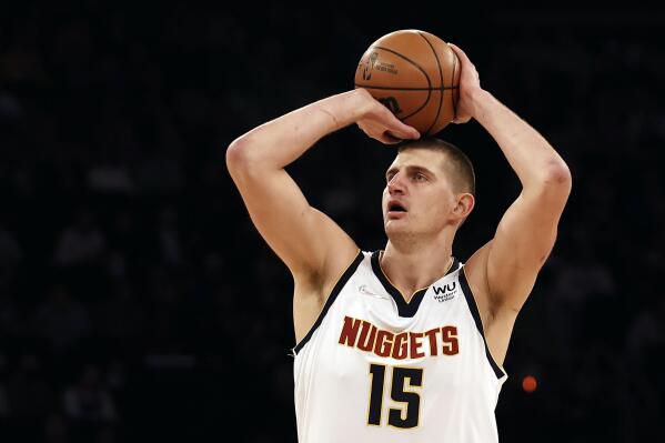Denver Nuggets center Nikola Jokic (15) shoots against the New York Knicks during the first half of an NBA basketball game Saturday, Dec. 4, 2021, in New York. (AP Photo/Adam Hunger)