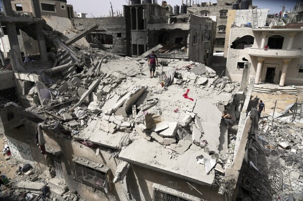 Palestinians inspect the house of the Jabr family after it was hit earlier by an Israeli army strike killing at least 10 people, in Jabalia, northern Gaza Strip, Sunday, May 18, 2025. (AP Photo/Jehad Alshrafi)