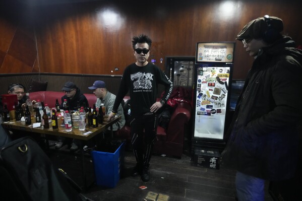 Dee, the singer of Chinese punk rock band Gum Bleed, waits backstage during a punk festival in Hangzhou, China, Friday, Jan. 17, 2025. (AP Photo/Aaron Favila)