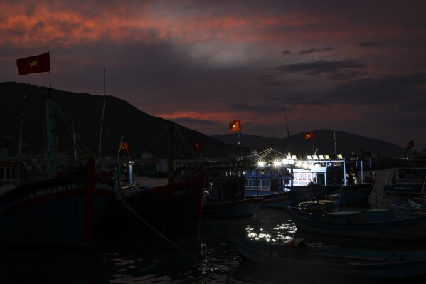 Fishing boats moored during sunset in the Nha Trang harbor to go squid fishing on Feb. 7, 2025, in Nha Trang, Vietnam. (AP Photo/Yannick Peterhans)