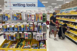 FILE - Shoppers look for school supplies at a store, Wednesday, July 27, 2022, in South Miami, Fla. Economists are saying strong consumer demand, spurred by rising wages, is fueling inflation. (AP Photo/Marta Lavandier, File)