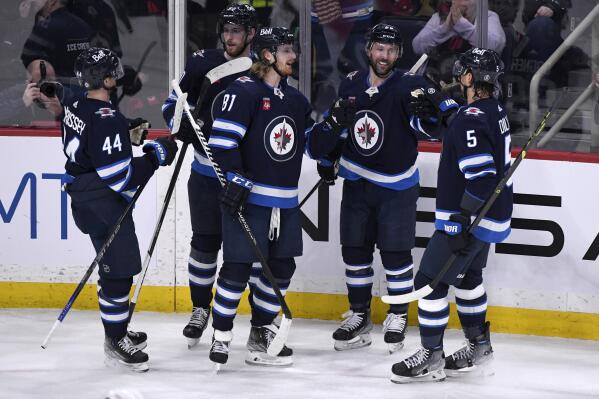 Winnipeg Jets' Sam Gagner (89) celebrates his goal against the Ottawa Senators with Josh Morrissey (44), Pierre-Luc Dubois (80), Kyle Connor (81) and Brenden Dillon (5) during the first period of an NHL hockey game Tuesday, Dec. 20, 2022, in Winnipeg, Manitoba. (Fred Greenslade/The Canadian Press via AP)