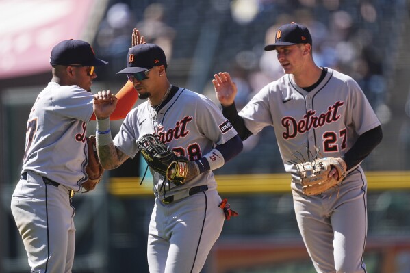 From left, Detroit Tigers second baseman Andy Ibáñez congratulates center fielder Javier Báez and shortstop Trey Sweeney after defeating the Colorado Rockies in the first baseball game of a doubleheader Thursday, May 8, 2025, in Denver. (AP Photo/David Zalubowski)