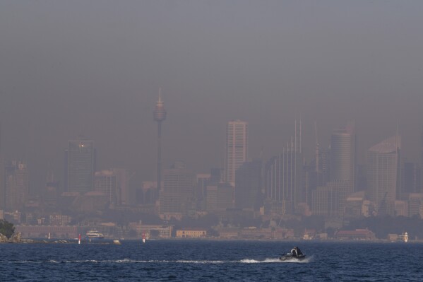 FILE - A thick blanket of smoke hangs over parts of the Sydney, Sept. 14, 2023, following New South Wales Rural Fire Service (RFS) hazard reduction burns in the past week. Sydney has on Tuesday, Sept. 19, 2023, experienced its first total fire ban in almost three years and several schools on the New South Wales state South Coast were closed because of a heightened wildfire danger with extraordinarily high temperatures across southeast Australia. (AP Photo/Mark Baker, File)