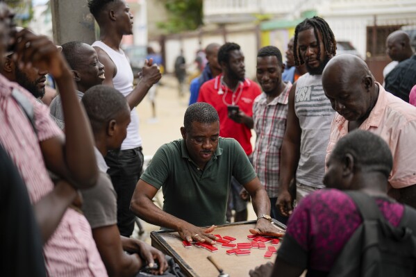 Men play dominoes in Cap-Haitien, Haiti, Wednesday, April 17, 2024. (AP Photo/Ramon Espinosa)