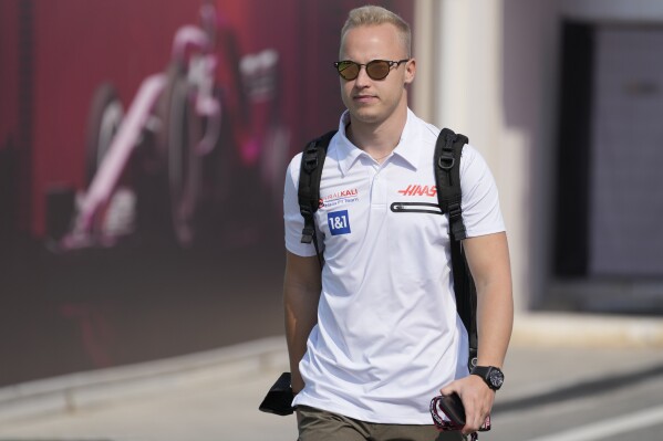 FILE - Haas driver Nikita Mazepin of Russia arrives to the Losail International Circuit in Losail, Qatar, Thursday, Nov. 18, 2021 ahead of the Qatar Formula One Grand Prix. The General Court of the European Union says ex-Formula One driver Nikita Mazepin should be removed from the EU lists of persons subjected to restrictive measures for their role in Russia’s war against Ukraine. Mazepin was added to the list of people sanctioned by the 27-nation bloc two years ago in the wake of Russia’s invasion because of his father’s connections to the Kremlin. (AP Photo/Darko Bandic, File)