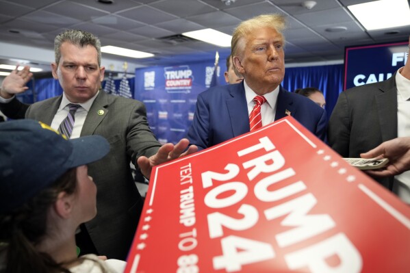 Republican presidential candidate former President Donald Trump signs autographs after speaking at a rally at Des Moines Area Community College in Newton, Iowa, Saturday, Jan. 6, 2024. (AP Photo/Andrew Harnik)