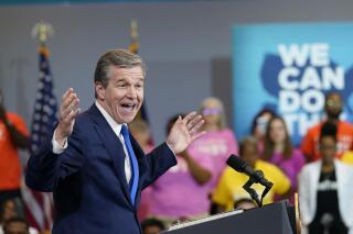 North Carolina Gov. Roy Cooper speaks before President Joe Biden during a visit to a mobile vaccination unit at the Green Road Community Center in Raleigh, N.C., Thursday, June 24, 2021. (AP Photo/Susan Walsh)
