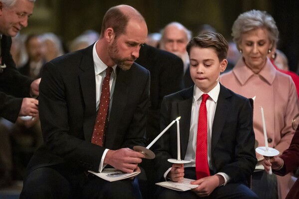 Britain's William, The Prince of Wales, left, and Prince George during the Together At Christmas carol service at Westminster Abbey, in London, Friday, Dec. 6, 2024. (Aaron Chown/Pool Photo via AP)