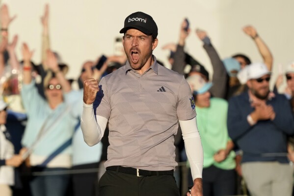 Nick Taylor, of Canada, celebrates after a regulation-tying birdie putt on the 18th hole, forcing a playoff with Charley Hoffman, during the final round of the Phoenix Open golf tournament Sunday, Feb. 11, 2024, in Scottsdale, Ariz. Taylor defeated Hoffman on the second playoff hole to win the tournament. (APPhoto/Ross D. Franklin)