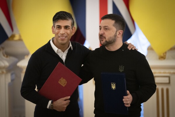 Britain's Prime Minister Rishi Sunak, left, hugs Ukrainian President Volodymyr Zelenskyy after signing documents in Kyiv, Ukraine, Friday, Jan. 12, 2024. (AP Photo/Efrem Lukatsky)