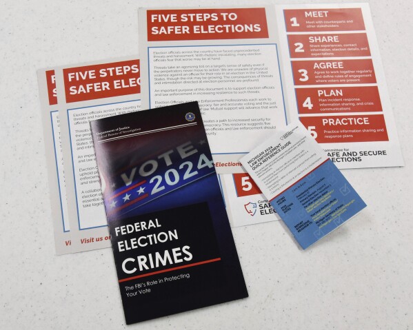 Educational materials provided by the Committee of Safe and Secure Elections are pictured at a conference with local election and law enforcement officials Wednesday, April 10, 2024, in Traverse City, Mich. A top concern for local election workers throughout the country this year is their own safety. The committee, formed after the 2020 presidential election, is traveling the country helping them prepare for what could lie ahead and making sure they are connected to local law enforcement. (AP Photo/John L. Russell)