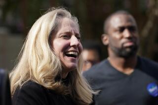 FILE- U.S. Rep. Abigail Spanberger, D-Va., smiles as she prepares to speak in Richmond, Va., Oct. 31, 2021. Draft maps for new congressional districts in Virginia would provide Democrats a strong chance to win six or seven of the state’s 11 seats, but they also draw Democratic Rep. Abigail Spanberger out of her Richmond-area district. (AP Photo/Steve Helber/FILE)