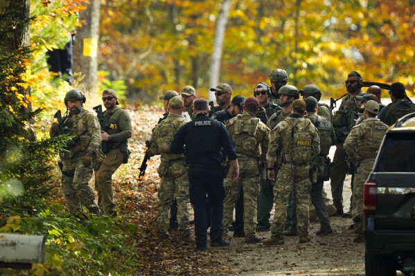 Law enforcement continue a manhunt in the aftermath of a mass shooting, in Durham, Maine, Friday, Oct. 27, 2023. Authorities are scouring hundreds of acres of family-owned property, sending dive teams to the bottom of a river and scrutinizing a possible suicide note in the second day of their intensive search for an Army reservist accused of fatally shooting several people in Maine.(AP Photo/Matt Rourke)