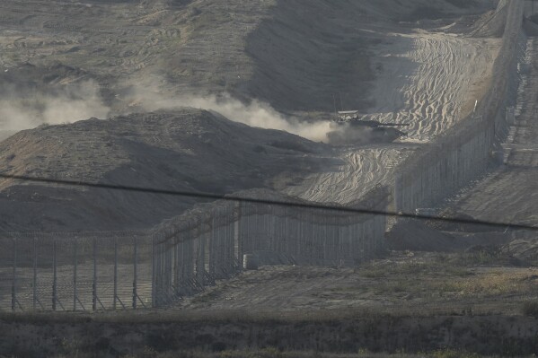 An Israeli tank maneuvers in the Gaza Strip, as seen from southern Israel, Friday, Nov. 10, 2023. (AP Photo/Leo Correa)