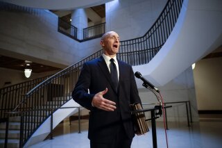 FILE - In a Nov. 2, 2017, file photo, Carter Page, a foreign policy adviser to Donald Trump's 2016 presidential campaign, speaks with reporters following a day of questions from the House Intelligence Committee, on Capitol Hill in Washington. The Justice Department has concluded that it should have ended its surveillance of a former Trump campaign adviser earlier than it did because it lacked “insufficient predication" to continue eavesdropping. That's according to an order made public Thursday by a secretive intelligence court. The FBI obtained a warrant in 2016 to eavesdrop on former Trump national security aide Carter Page on suspicions that he was secretly a Russian agent. The Justice Department renewed the warrant three times, including during the early months of the Trump administration. But the Justice Department's inspector general has harshly criticized the FBI's handing of those applications. (AP Photo/J. Scott Applewhite, File)