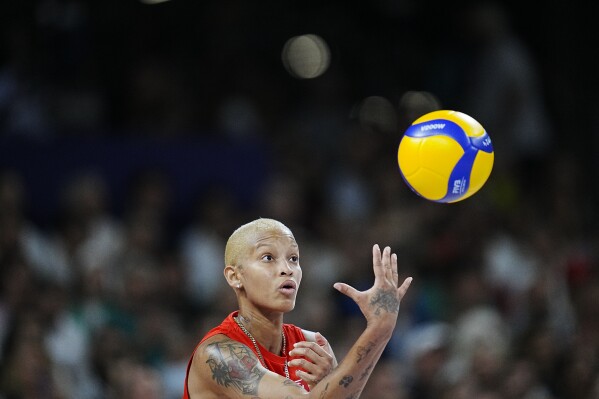 Melissa Teresa Vargas of Turkey prepares to serve the ball against Italy during the Group C women's volleyball match between Italy and Turkey at the 2024 Summer Olympics, Sunday, Aug. 4, 2024, in Paris, France. (AP Photo/Dolores Ochoa)
