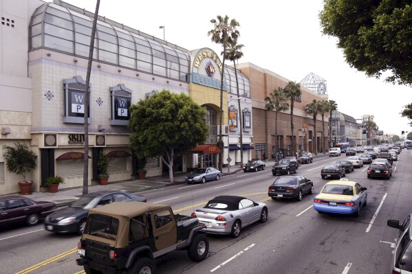 FILE - Traffic passes the Westside Pavilion shopping mall in Los Angeles, April 29, 2004. The University of California, Los Angeles, will turn the sprawling former shopping mall into cutting-edge centers for immunology and quantum science research. California Gov. Gavin Newsom and university officials announced the plan for the former Westside Pavilion at a news conference Wednesday, Jan. 3, 2024. (AP Photo/Nick Ut, File)
