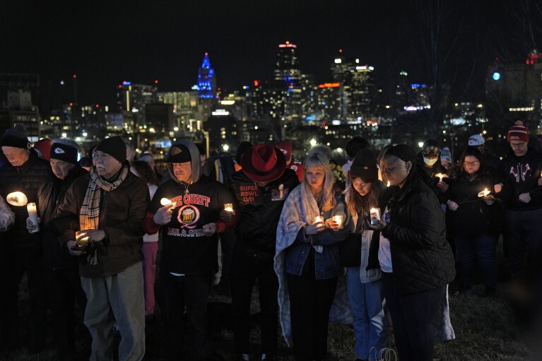 People on Thursday, February 15, 2024 in Kansas City, MO.  Attended a candlelight vigil for the victims of the shooting at the Kansas City Chiefs Super Bowl victory rally in.  More than 20 people were injured and a woman died in the shooting late Wednesday.  The rally was held at nearby Union Station.  (AP Photo/Charlie Riedel)