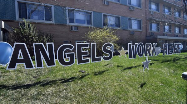 A tribute to health care workers adorns the lawn in front of the Olivet Home Thursday, April 30, 2020 in Minneapolis. (AP Photo/Jim Mone)