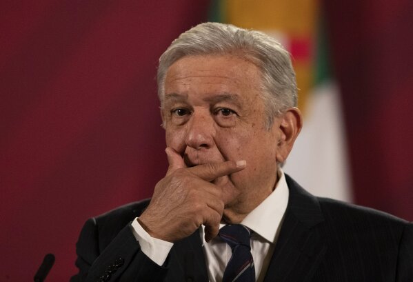 Mexican President Andres Manuel Lopez Obrador gives his daily, morning news conference at the presidential palace, Palacio Nacional, in Mexico City, Friday, Oct. 16, 2020. López Obrador said Friday that his ambassador to the United States told him two weeks ago that there was an investigation underway there involving Mexico's former defense secretary, retired Gen. Salvador Cienfuegos, who was arrested Thursday in Los Angeles. (AP Photo/Marco Ugarte)