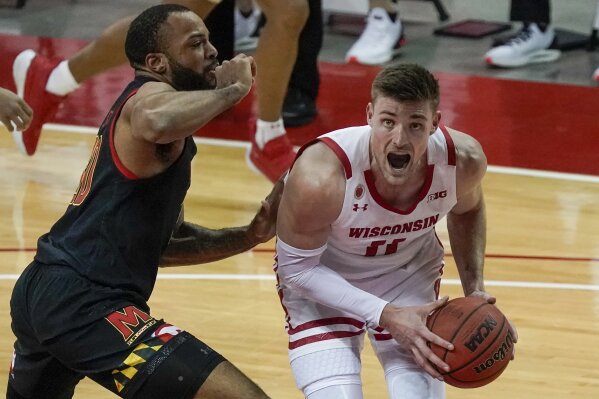 Wisconsin's Micah Potter tries to get past Maryland's Galin Smith during the second half of an NCAA college basketball game Monday, Dec. 28, 2020, in Madison, Wis. (AP Photo/Morry Gash)