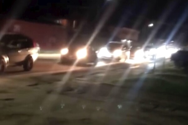 This image taken from video provided by Viral Tonganz shows vehicles in traffic after a strong 7.1 magnitude earthquake hit near Tonga, prompting an initial tsunami warning that was later lifted for the Pacific island country. (Viral Tonganz via AP)
