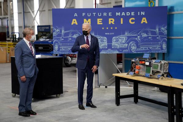 President Joe Biden speaks with William "Bill" Ford, Jr., Executive Chairman, Ford Motor Company, left, as he tours the Ford Rouge EV Center, Tuesday, May 18, 2021, in Dearborn, Mich. (AP Photo/Evan Vucci)