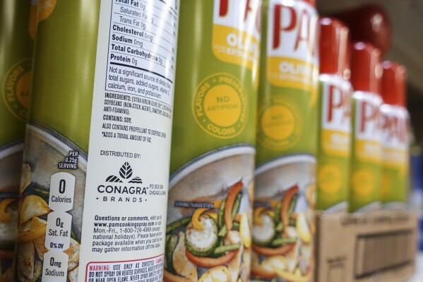FILE - Cooking spray oils by Pam, a Conagra brand, rest on a supermarket shelf, June 25, 2019, in Cincinnati. On Monday, Oct. 30, 2023, a jury in Illinois ordered Chicago-based Conagra Brands to pay $7.1 million to a Pennsylvania woman who was badly injured in 2017 when a can of commercial brand cooking spray ignited in a kitchen at her workplace and set her aflame. The verdict is the first of numerous other cases from burn victims across the country with similar stories citing accidents that occurred with Conagra-made cooking spray brands, including its popular grocery store brand Pam. (AP Photo/John Minchillo, File)