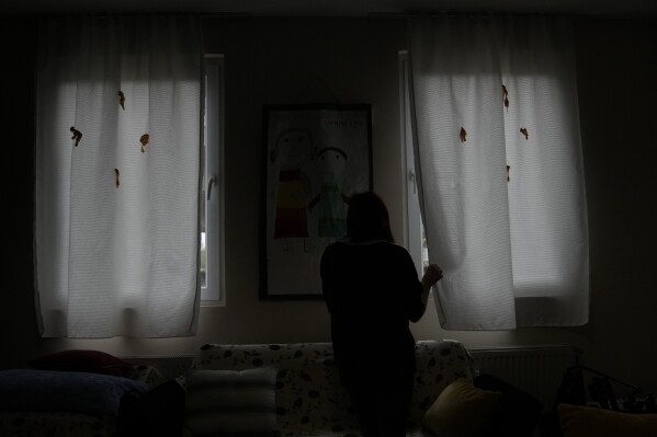 A 26-year-old woman, who declined to be named for security reasons, looks out the window at a safe house for women in Belgrade, Serbia, Thursday, Nov. 23, 2023.  She said her partner repeatedly raped, beat and strangled her.  Kept her and her child locked in their flat for hours.  Throughout the Western Balkans, women are often harassed, raped, beaten, and killed by their partners and after repeatedly reporting the violence to authorities.  (AP Photo/Darko Vojinovic)