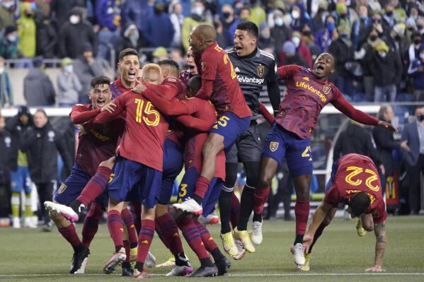 Real Salt Lake players celebrate a win over the Seattle Sounders on penalty kicks in an MLS soccer playoff  match Tuesday, Nov. 23, 2021, in Seattle. (AP Photo/Ted S. Warren)