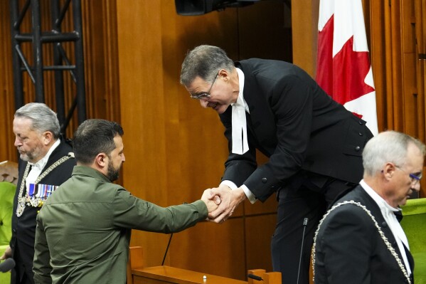 The Speaker of the House of Commons Anthony Rota shakes hands with Ukrainian President Volodymyr Zelenskyy in the House of Commons on Parliament Hill in Ottawa on Friday, Sept. 22, 2023. Rota is apologizing for recognizing in Parliament a man who fought for a Nazi military unit during World War II, just after Zelenskyy addressed the House of Commons on Friday. (Sean Kilpatrick/The Canadian Press via AP)