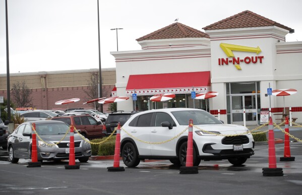 Customers line up at the In-N-Out drive-thru off Hegenberger Road in Oakland, Calif., on Monday, Jan. 22, 2024. In-N-Out will close its only restaurant in Oakland because of a wave of car break-ins, property damage, theft and armed robberies targeting customers and employees alike, the company announced. The burger joint in a busy corridor near the Oakland International Airport will close on March 24, 2024. (Jane Tyska/Bay Area News Group via AP)