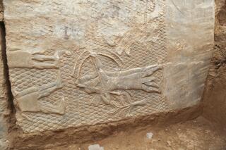 A 2,700-year-old rock carving is seen in Mosul, Iraq, , is seen on Monday, Oct. 24, 2022. The carvings on marble slabs were discovered by a team of experts in Mosul, Iraq's second-largest city, who have been working to restore the site of the ancient Mashki Gate, which was bulldozed by Islamic State group militants in 2016. (AP Photo/Farid Abdulwahed)