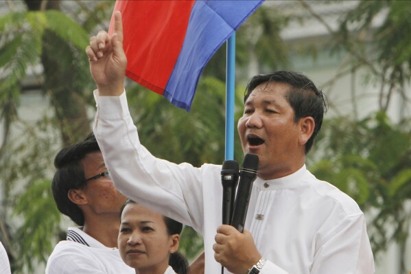 FILE - Thach Setha, a prominent vice president of the country's main opposition, Candlelight Party, talks to media members near the Vietnam Embassy in Phnom Penh, Cambodia, on Aug. 10, 2014. A top Cambodian opposition politician who was sentenced last month to 18 months in prison for issuing worthless checks has been convicted and sentenced to three years additional imprisonment for incitement to commit a felony and incitement to discriminate on the basis of race, religion or nationality. (AP Photo/Heng Sinith, File)