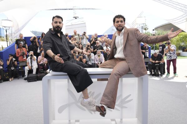 Director Morad Mostafa, left, and Mostafa Elkashef pose for photographers at the photo call for the film 'Aisha Can't Fly Away' at the 78th international film festival, Cannes, southern France, Wednesday, May 21, 2025. (AP Photo/Natacha Pisarenko)