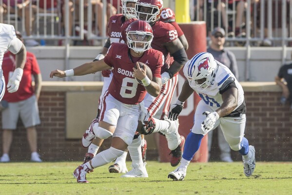 Oklahoma quarterback Dillon Gabriel (8) carries for a first down during the first half of the team's NCAA college football game against SMU, Saturday, Sept. 9, 2023, in Norman, Okla. (AP Photo/Alonzo Adams)