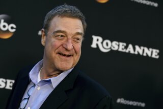 FILE - In this March 23, 2018 file photo, John Goodman arrives at the Los Angeles premiere of "Roseanne" in Burbank, Calif. Goodman is speculating that this fall's "Roseanne" spinoff will mean curtains for the matriarch played by Roseanne Barr. In an interview with the Sunday Times of London, Goodman said he wasn't sure how the new series, titled "The Conners," will be structured. (Photo by Jordan Strauss/Invision/AP, File)