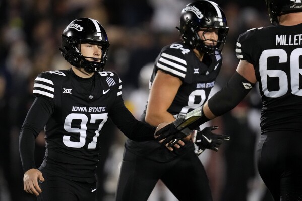 Iowa State place kicker Kyle Konrardy (97) celebrates with teammates after kicking a 35-yard field goal during the first half of an NCAA college football game against Cincinnati, Saturday, Nov. 16, 2024, in Ames, Iowa. (AP Photo/Charlie Neibergall)
