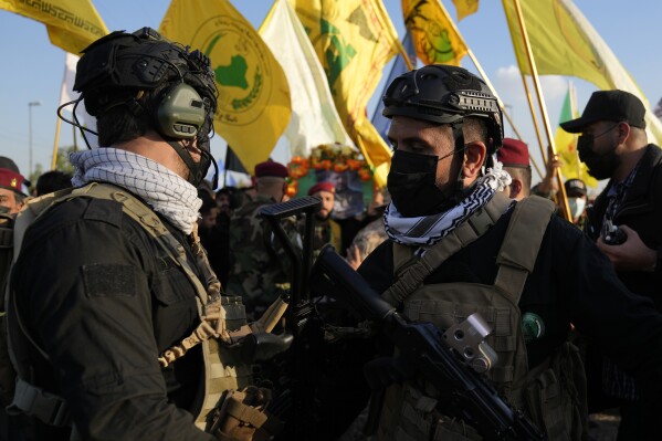 Fighters from the Popular Mobilization Forces, attends the funeral of a commander from the Kataib Hezbollah paramilitary group, Wissam Muhammad Sabir Al-Saadi, known as Abu Baqir Al-Saadi, who was killed in a U.S. airstrike, in Baghdad, Iraq, Thursday, Feb. 8, 2024. (AP Photo/Hadi Mizban)