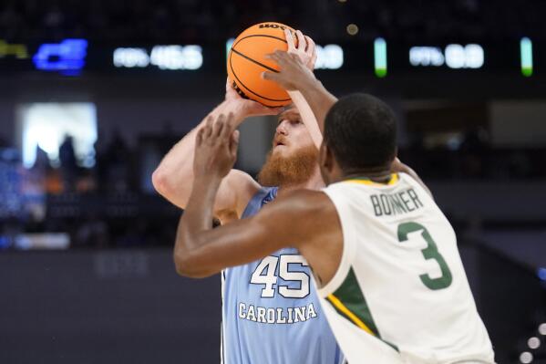 North Carolina forward Brady Manek (45) shoots a 3-point basket as Baylor guard Dale Bonner (3) defends in the first half of a second-round game in the NCAA college basketball tournament in Fort Worth, Texas, Saturday, March, 19, 2022. (AP Photo/Tony Gutierrez)