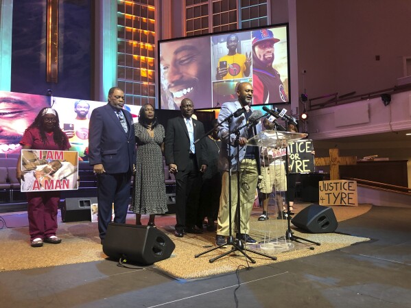 Tyre Nichols' stepfather Rodney Wells, second left, and Nichols' mother RowVaughn Wells, third left, close their eyes in prayer before a news conference about federal charges filed against five former officers in Nichols' death on Tuesday, Sept. 12, 2023, in Memphis, Tenn. Also pictured are attorney Ben Crump, fourth left, and pastor Earle Fisher, at lectern. AP Photo/Adrian Sainz)