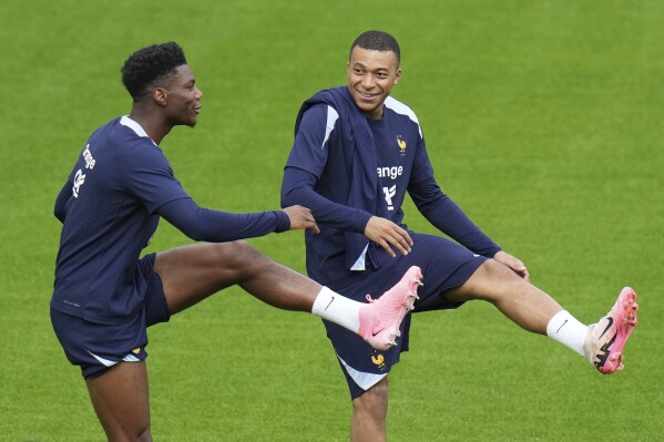 France's Kylian Mbappe, right, and France's Aurelien Tchouameni warm up during a training session in Paderborn, Germany, Saturday, June 15, 2024. France will play against Austria during their Group D soccer match at the Euro 2024 soccer tournament on June 17. (AP Photo/Hassan Ammar)