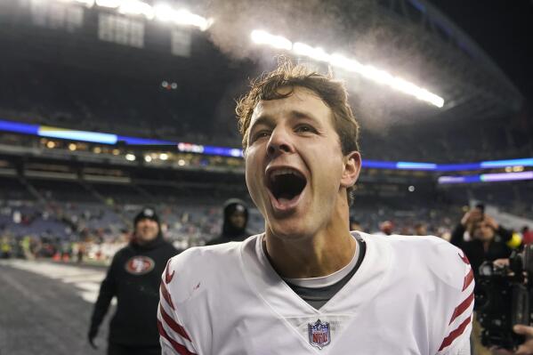 San Francisco 49ers quarterback Brock Purdy celebrates after the 49ers defeated the Seattle Seahawks in an NFL football game in Seattle, Thursday, Dec. 15, 2022. (AP Photo/Marcio Jose Sanchez)