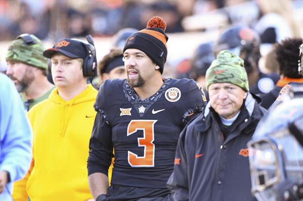 Oklahoma State quarterback Spencer Sanders (3) stands on the sideline watching his team during the first half of an NCAA college football game against Iowa State, Saturday, Nov. 12, 2022, in Stillwater, Okla. (AP Photo/Brody Schmidt)