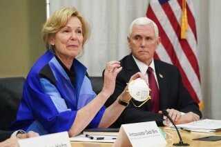 FILE - In this March 5, 2020, file photo, Dr. Deborah Birx, Ambassador and White House coronavirus response coordinator, holds a 3M N95 mask as she and Vice President Mike Pence visit 3M headquarters in Maplewood, Minn., in a meeting with the company's leaders and Minnesota Gov. Tim Walz to coordinate response to the COVID-19 coronavirus. On Friday, April 3, 2020, the manufacturing giant pushed back against criticism from Trump over production of face masks that are badly needed by American health care workers. 3M said the administration asked it to stop exporting medical-grade masks to Canada and Latin America, which the company said raises “significant humanitarian implications” and will backfire by causing other countries to retaliate against the U.S. (Glen Stubbe/Star Tribune via AP, File)/Star Tribune via AP)
