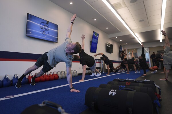 Two-time IndyCar series champion Josef Newgarden, left, leads a group through the paces of his physical workout, a cross-fit session designed to fine-tune the entire body for strength and endurance in racing, Thursday, March 13, 2025, in Austin, Texas. (AP Photo/Eric Gay)