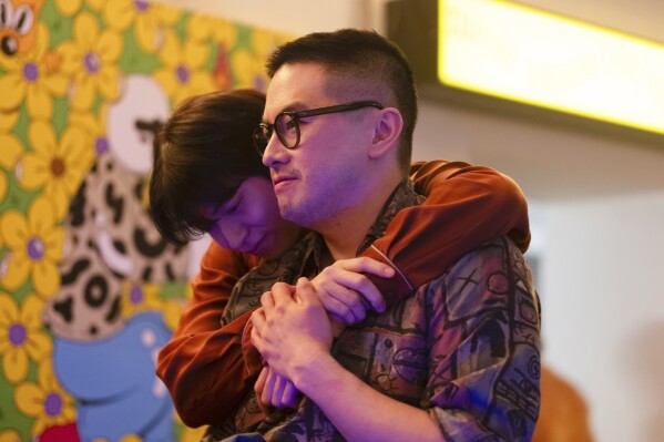 This image released by Bleecker Street shows Han Gi-Chan, background, Bowen Yang in a scene from "The Wedding Banquet." (Bleecker Street via AP)