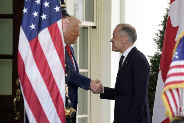 Prime Minister Mark Carney arrives and greets U.S. President Donald Trump prior to a meeting at the White House in Washington, D.C., Tuesday, May 6, 2025. (Adrian Wyld /The Canadian Press via AP)