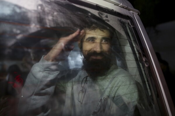 a freed palestinian prisoner waves as he arrives in the gaza strip after being released from an israeli prison following a ceasefire agreement between hamas and israel in khan younis, thursday, jan. 30, 2025. (ap photo/jehad alshrafi)